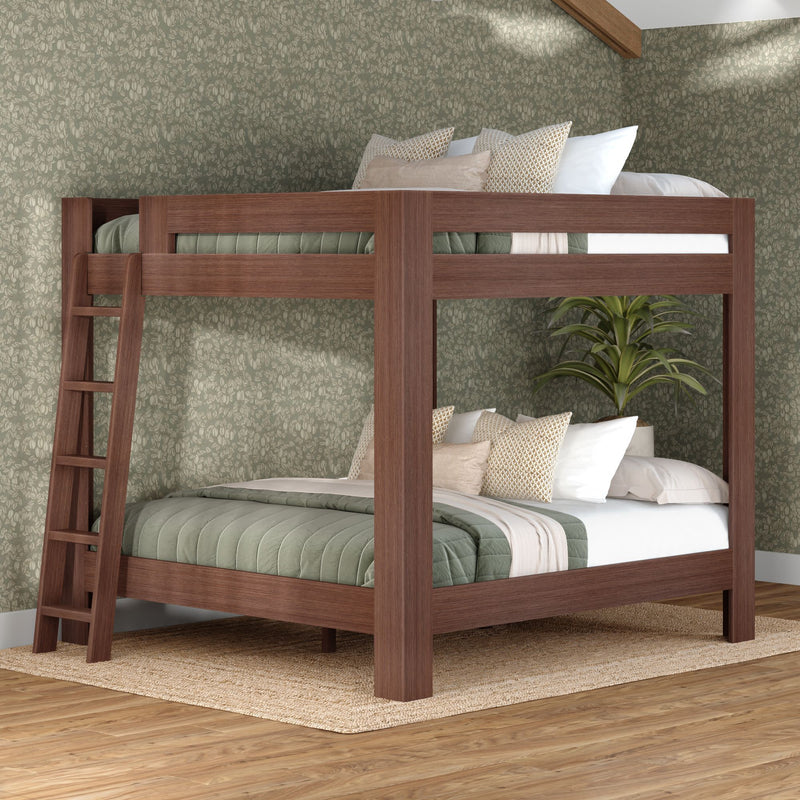 Walnut solid-wood twin-over-full bunk bed with ladder, green quilted bedding, neutral throw pillows, floral wallpaper and jute rug in modern bedroom