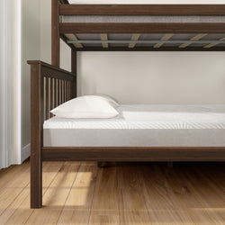 Wooden bunk bed with white mattresses and pillows in a modern bedroom.