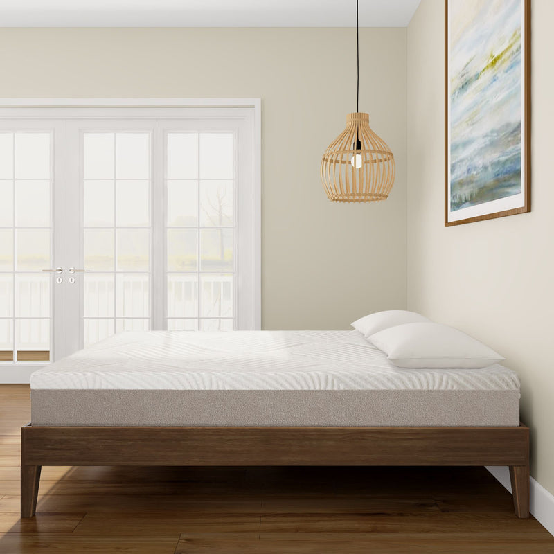 Modern bedroom with a minimalist bed frame, comfortable mattress, and soft pillows, featuring natural light from large windows and stylish decor.
