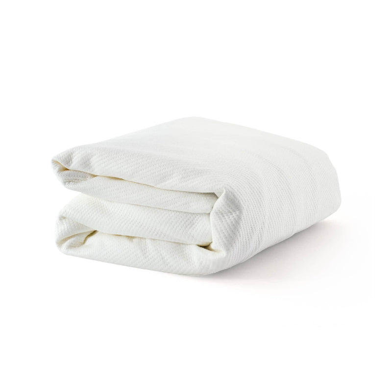 Folded white blanket on white background, perfect for bedroom decor and comfort.