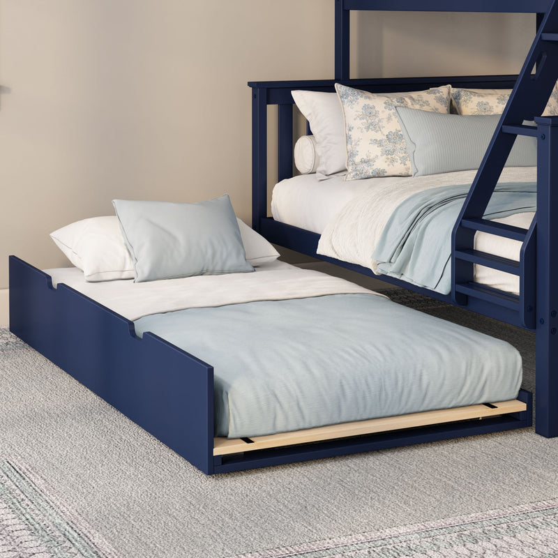 Navy blue bunk bed with pull-out trundle, light blue and white bedding, floral accent pillows and ladder in a neutral kids' bedroom