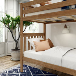 Cozy modern bedroom with wooden bunk bed, white bedding, and decorative indoor plant.