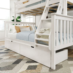 White wooden bunk bed with a staircase and storage drawers, featuring cozy bedding, in a well-lit bedroom.