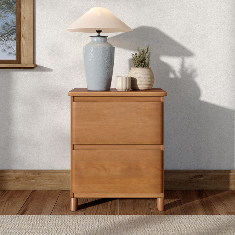 Wooden nightstand with blue ceramic table lamp, small potted plant and candle on dresser in bright minimalist bedroom decor