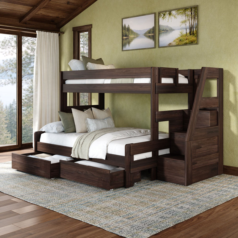 Dark wood bunk bed with stairs and pull-out trundle drawers in a cozy rustic bedroom with green accent wall, large window and nature artwork