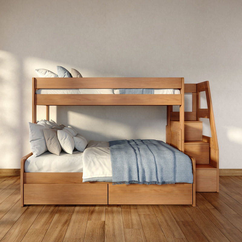Modern light-wood bunk bed with staircase and built-in drawers, neutral pillows and blue throw in minimalist kids' bedroom