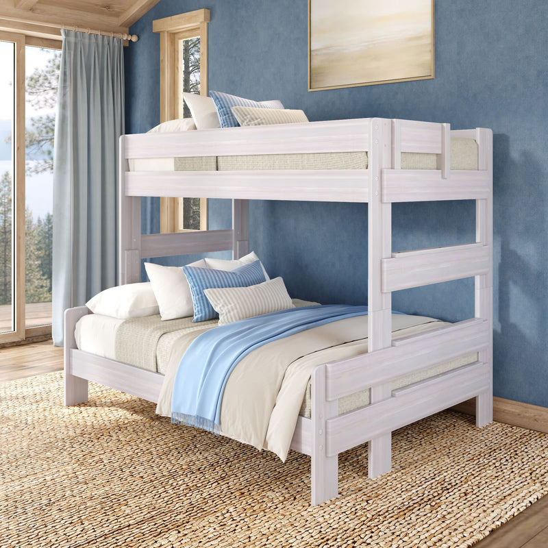 Whitewashed wooden bunk bed in coastal-style bedroom with blue walls, large windows, neutral bedding, blue-striped pillows and jute rug