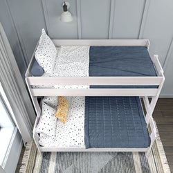 White wooden bunk bed with polka dot bedding and blue blankets in a modern bedroom.