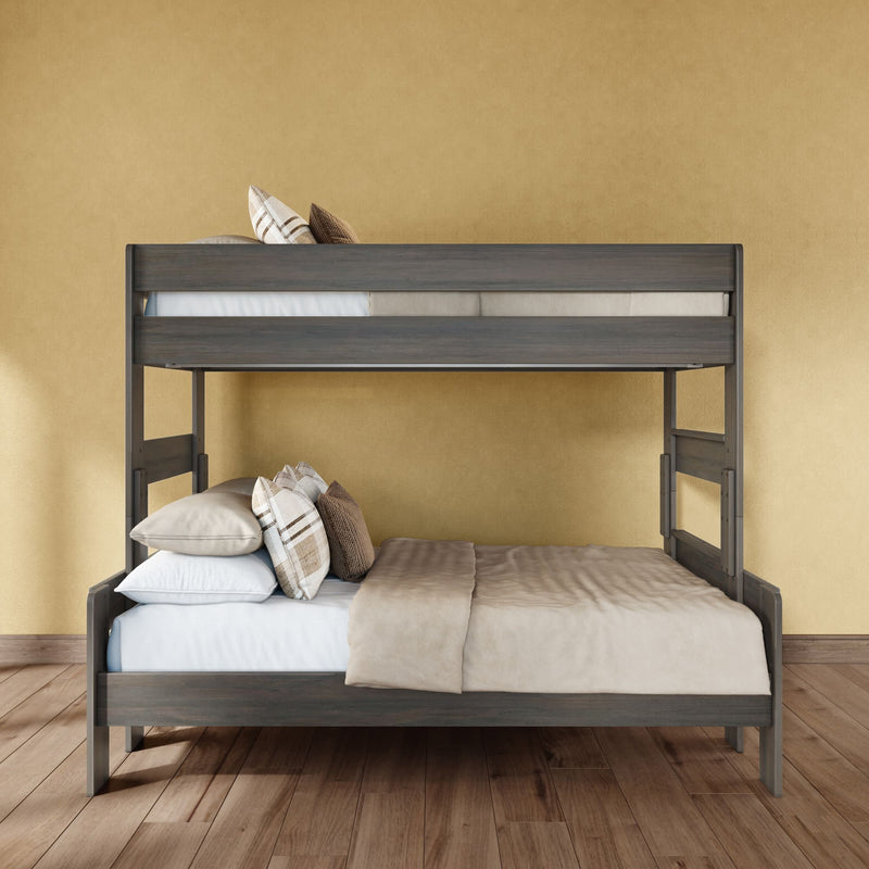 Gray wooden bunk bed with full-size lower bed and twin upper bed, beige bedding and plaid throw pillows in a space-saving modern bedroom with hardwood floor and yellow textured wall