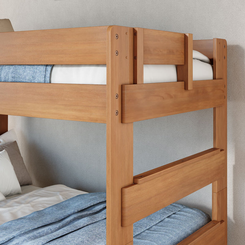 Solid wood twin bunk bed with natural oak finish, blue linens and guardrails in a modern space-saving kids' bedroom