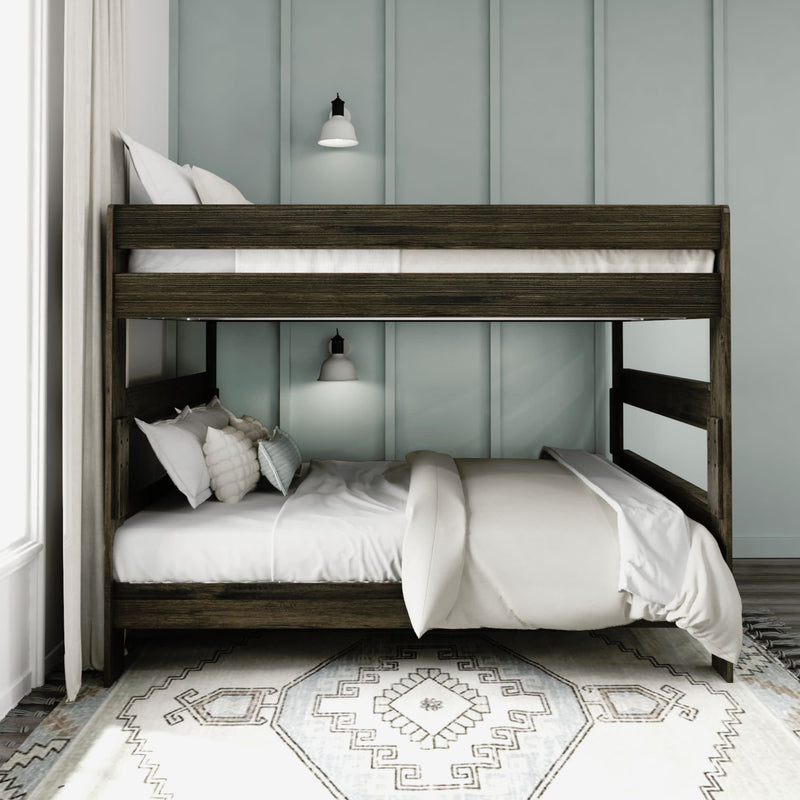 Modern wooden bunk bed with white bedding in a stylish bedroom featuring soft lighting and a geometric rug.