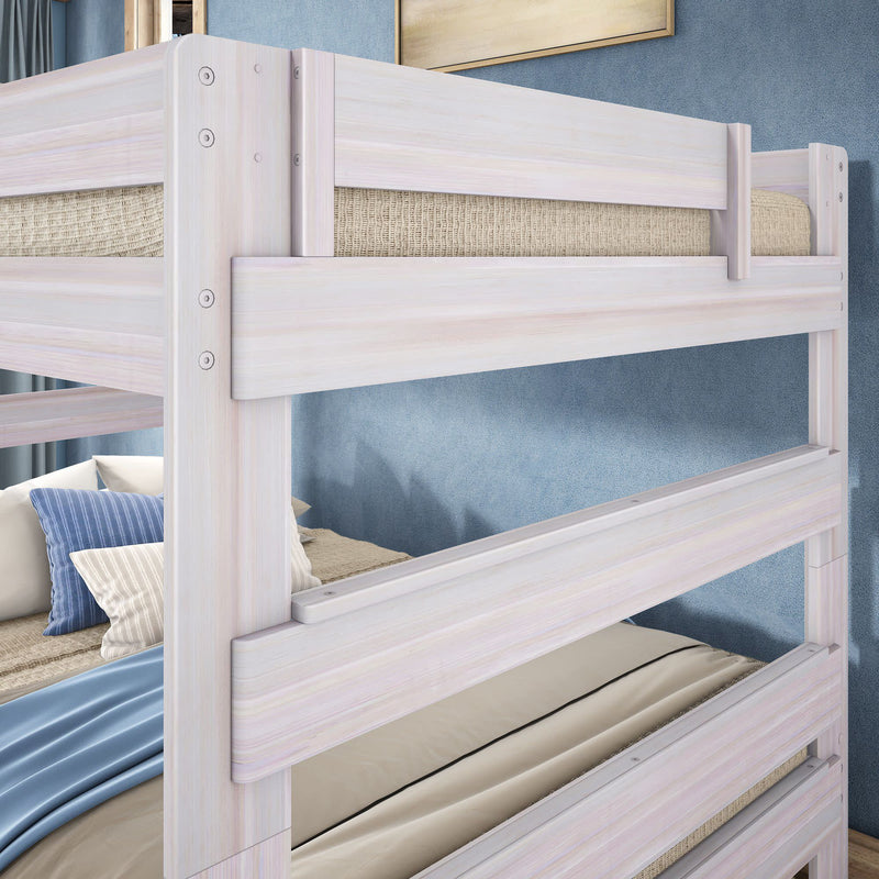 Whitewashed solid wood twin-over-twin bunk bed with safety rails, neutral bedding and blue accent pillows in a modern coastal kids bedroom