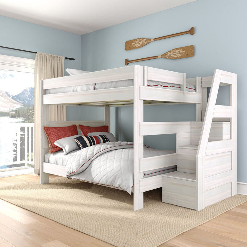 White wood twin-over-full bunk bed with staircase storage in light-blue bedroom, red accent pillows and lake-view window