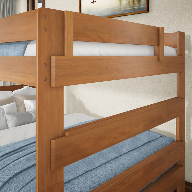 Solid natural wood bunk bed frame with sturdy guardrails and blue linen bedding in a modern bedroom