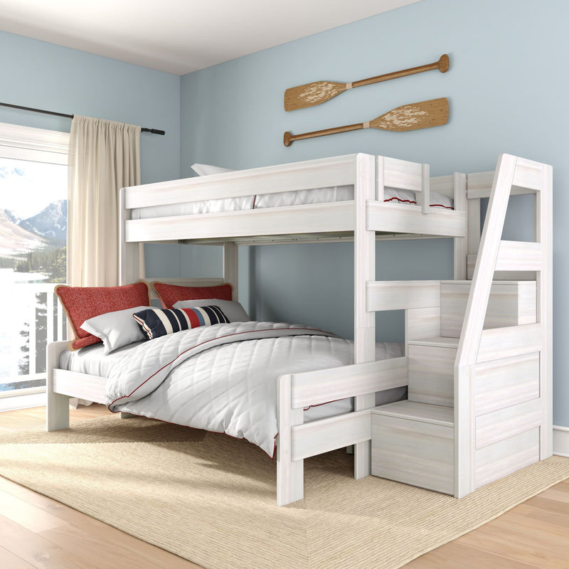 White wooden twin-over-full bunk bed with staircase in coastal blue bedroom, nautical oar wall decor, red and striped pillows and lake view window