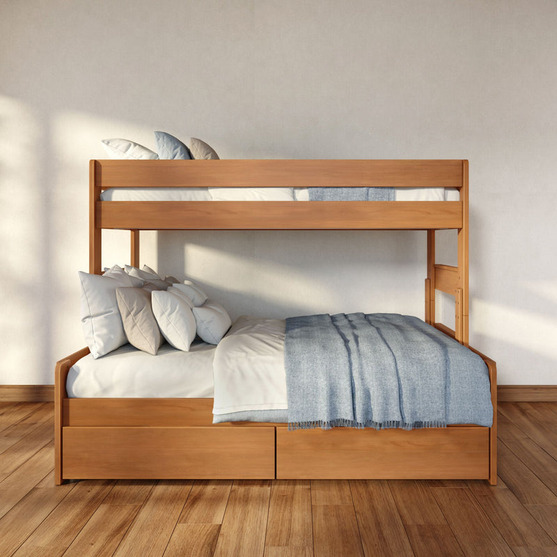 Modern wooden bunk bed with blue bedding and white pillows, built-in storage drawers on hardwood floor in a minimalist sunlit bedroom — space-saving kids' room furniture