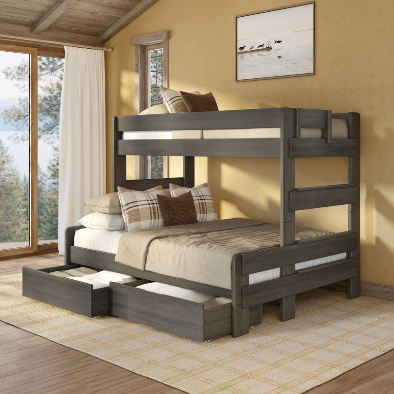 Rustic wooden bunk bed with pull-out trundle drawers in cozy cabin bedroom with neutral bedding and plaid pillows