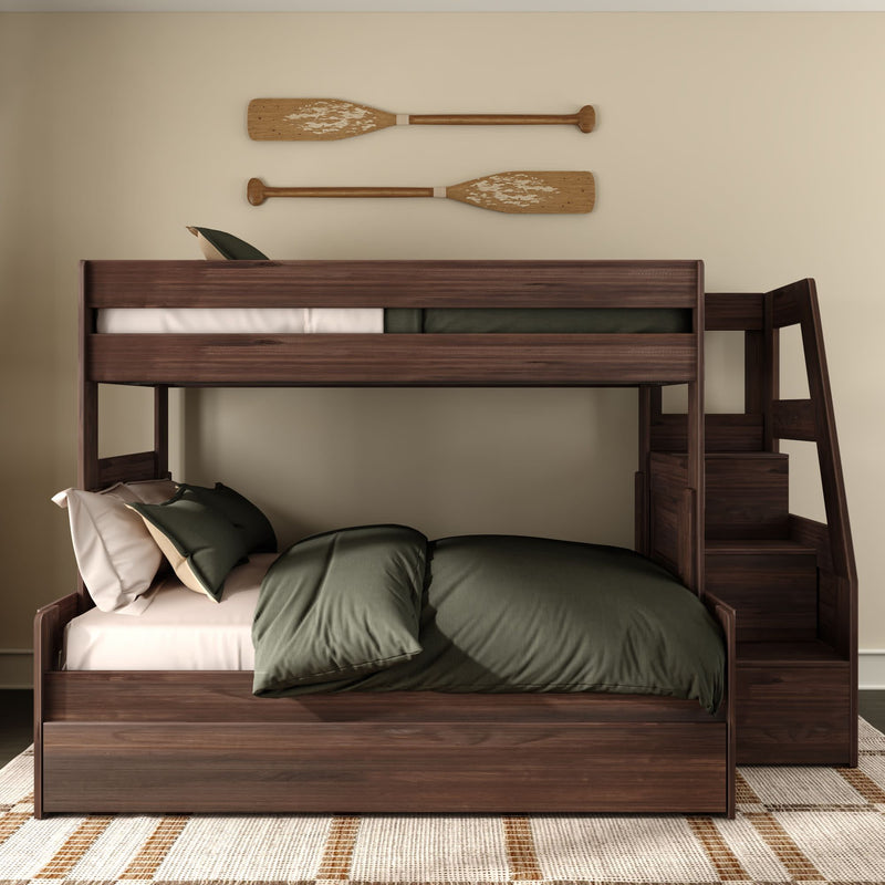 Dark walnut wooden bunk bed with staircase storage and green bedding in a neutral bedroom with mounted decorative oars