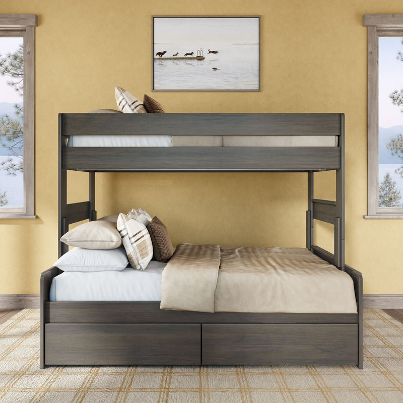 Gray wooden twin-over-full bunk bed with under-bed storage drawers, beige bedding and plaid pillows in a cozy neutral bedroom with yellow walls and framed lake artwork.