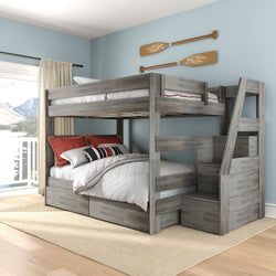 Gray rustic full-over-full wooden bunk bed with built-in storage staircase and under-bed drawers, white quilt and red accent pillows in coastal bedroom with oar wall decor and lake-view balcony
