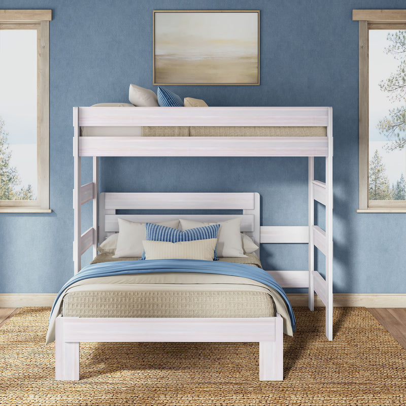White wooden twin-over-full bunk bed in coastal blue bedroom with woven rug, layered bedding and decorative pillows — space-saving kids' bedroom furniture