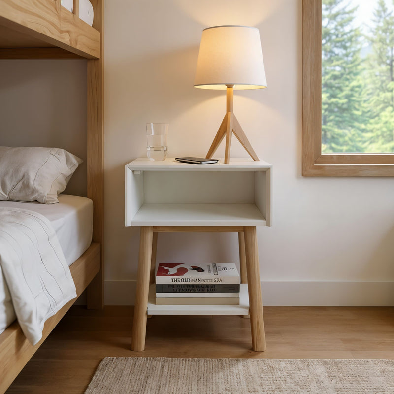 Minimalist bedroom design with a wooden bedside table, modern lamp, and stacked books.