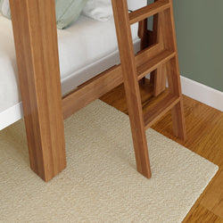 Wooden ladder next to a white bed on a beige textured carpet in a cozy room.