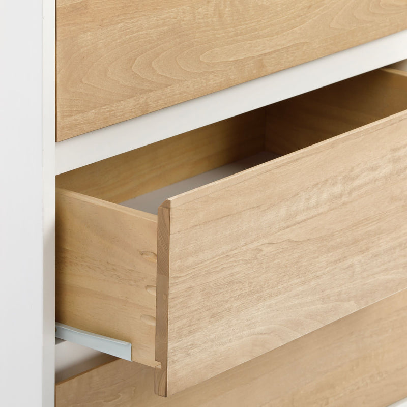 Open wooden drawer of a modern light wood dresser with smooth finish and minimalist design.
