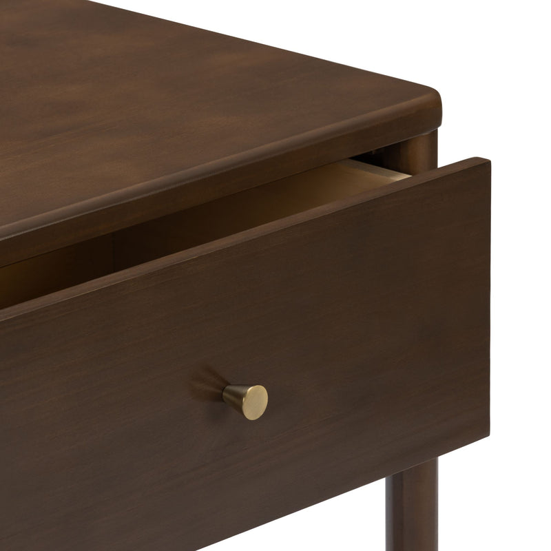 Close-up of dark brown wooden nightstand drawer with brass knob, rounded top edge and slightly open interior, modern bedside table finish