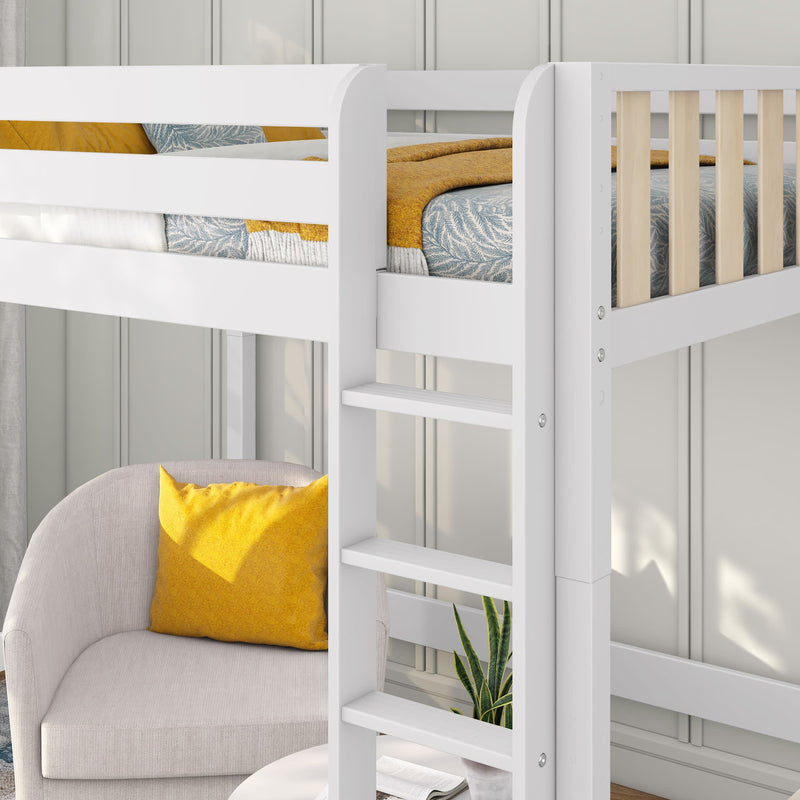 White wooden loft bed with ladder and natural wood slats above a cozy gray armchair with mustard yellow pillow and patterned blue bedding