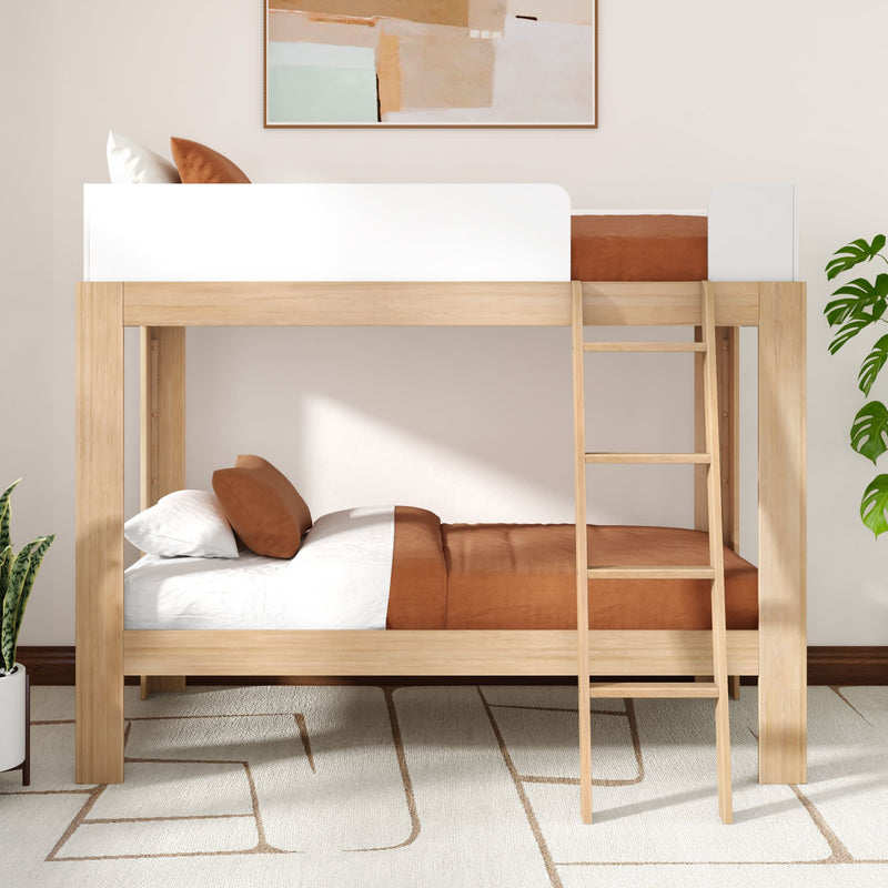 Modern natural wood twin-over-twin bunk bed with ladder, brown and white bedding in a minimalist kids' bedroom with rug, potted plants and abstract wall art