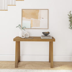 Minimalist wooden console table with decorative vases and abstract wall art, perfect for modern home decor.
