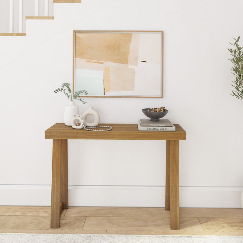 Minimalist wooden console table with decorative vases and abstract wall art, perfect for modern home decor.