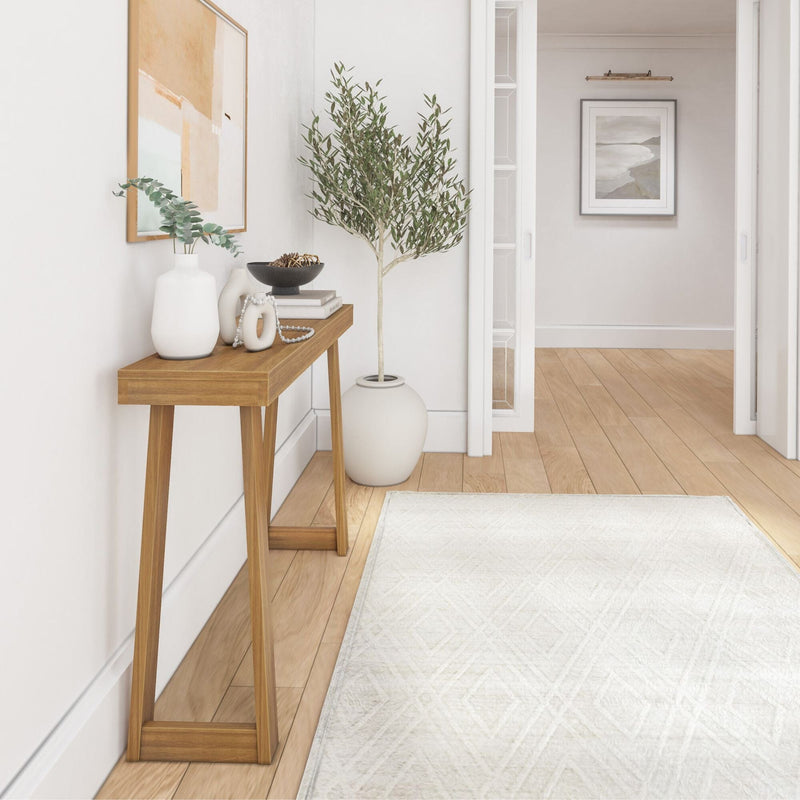 Modern minimalist entryway with wooden console table, decorative vases, and indoor plant in a white-walled hallway.