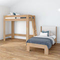 Modern minimalist bedroom with natural wood loft bed and matching single bed, blue patterned bedding, hardwood floors and white walls