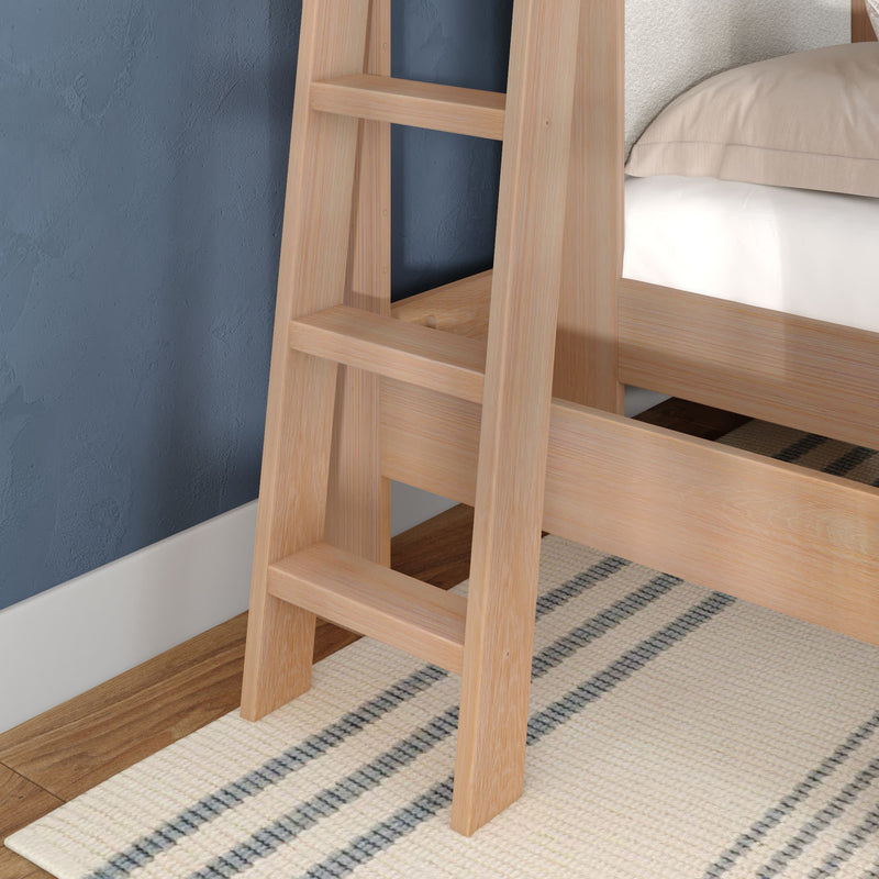 Light oak wooden bunk bed ladder against a navy textured wall on a striped neutral rug — modern children's loft bed bedroom detail