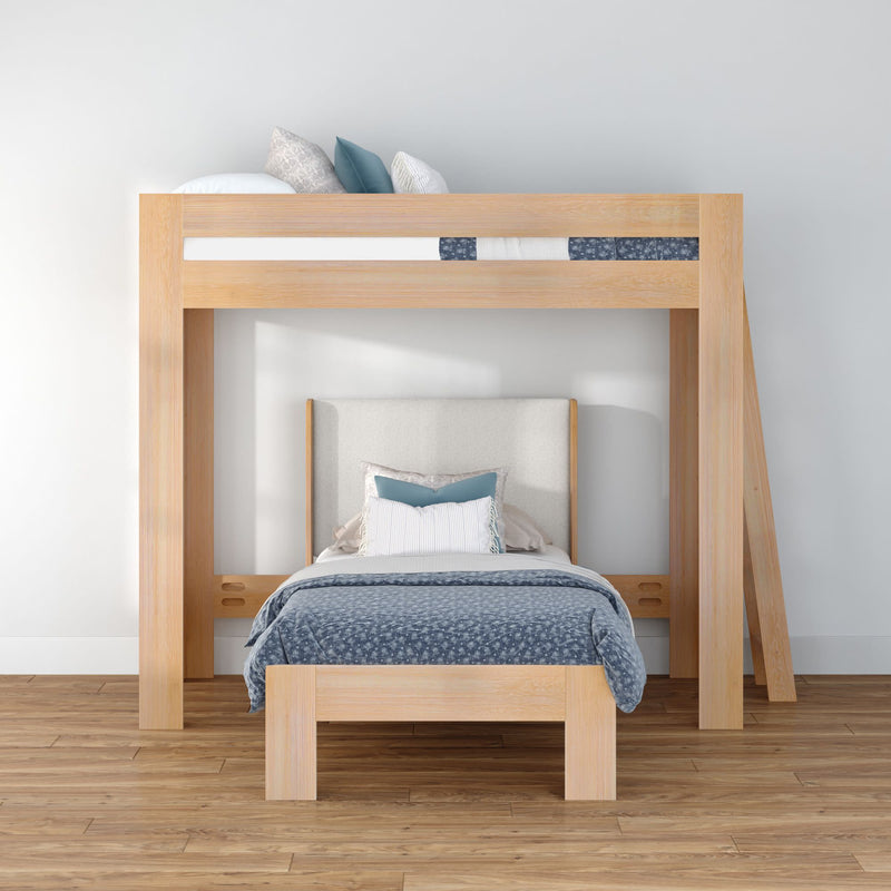 Modern light wood loft bunk bed (twin-over-twin) with lower single bed, blue patterned bedding and pillows in a minimalist Scandinavian kids bedroom, space-saving design