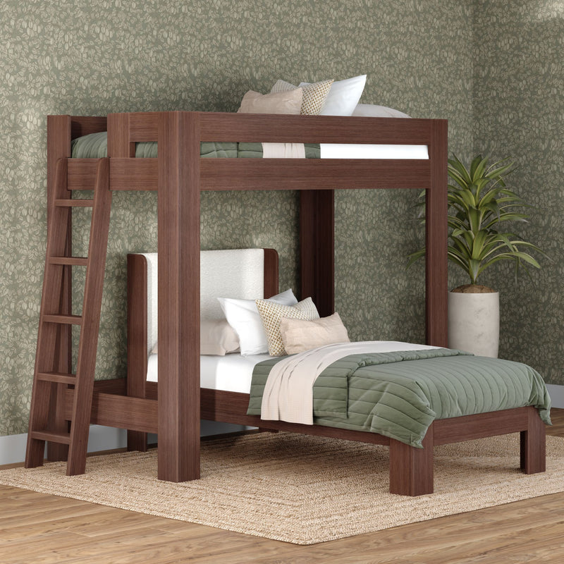 Dark walnut solid-wood twin-over-full bunk bed with ladder, green quilted bedding, decorative pillows and patterned wallpaper