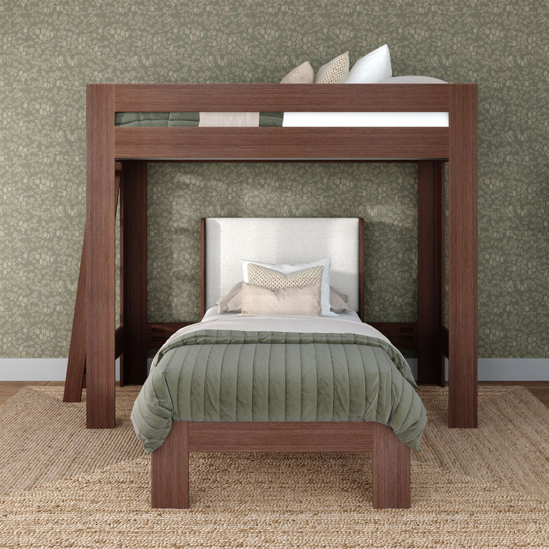 Wooden loft bunk bed with lower twin bed, olive green quilted bedding and decorative pillows against floral green wallpaper and jute rug in a modern kids' bedroom