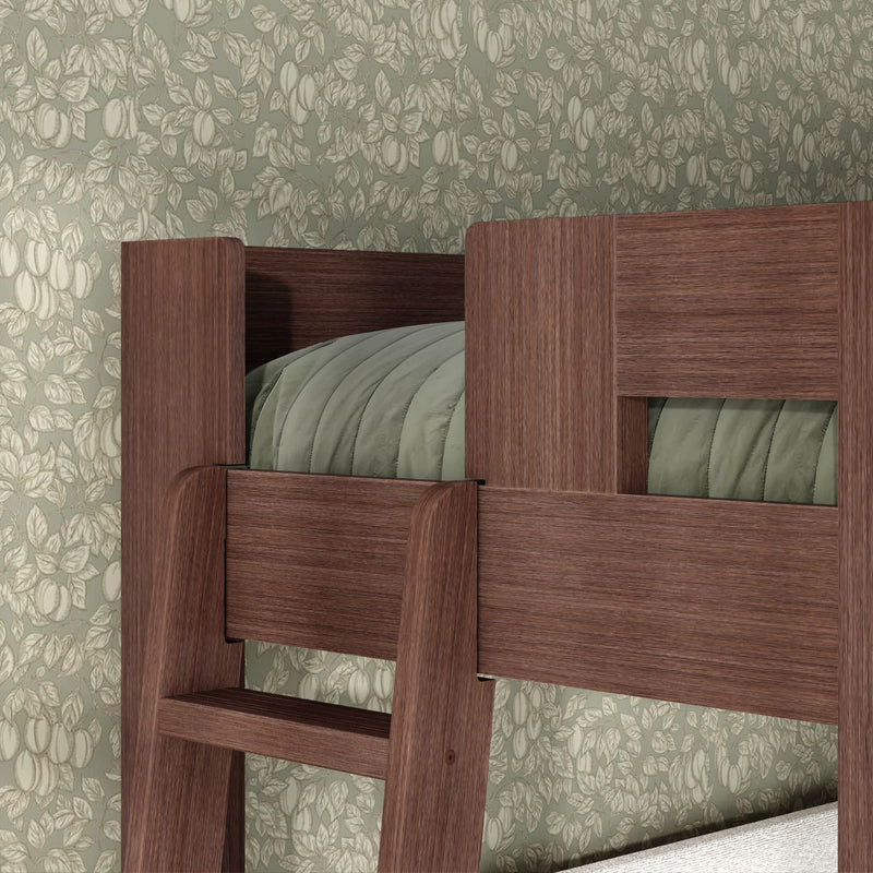 Dark walnut wooden bunk bed ladder and safety rail with sage green quilted bedding against floral wallpaper — space-saving bedroom interior