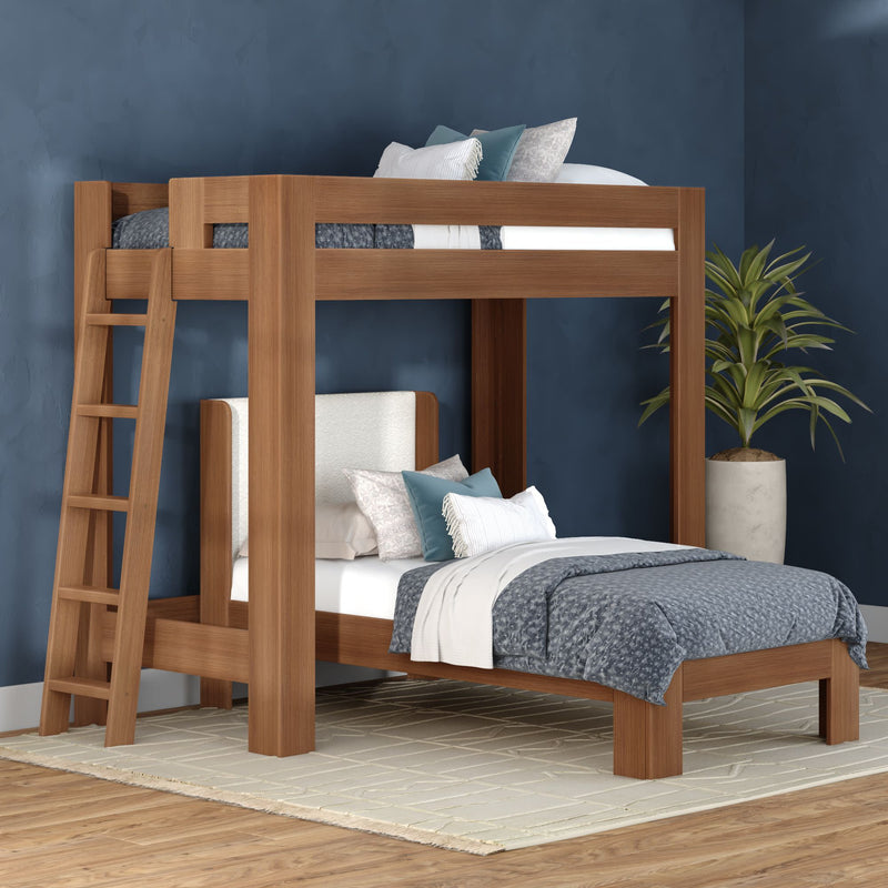 Solid wood loft bunk bed with built-in ladder and gray-blue bedding in a modern bedroom with navy accent wall and potted plant
