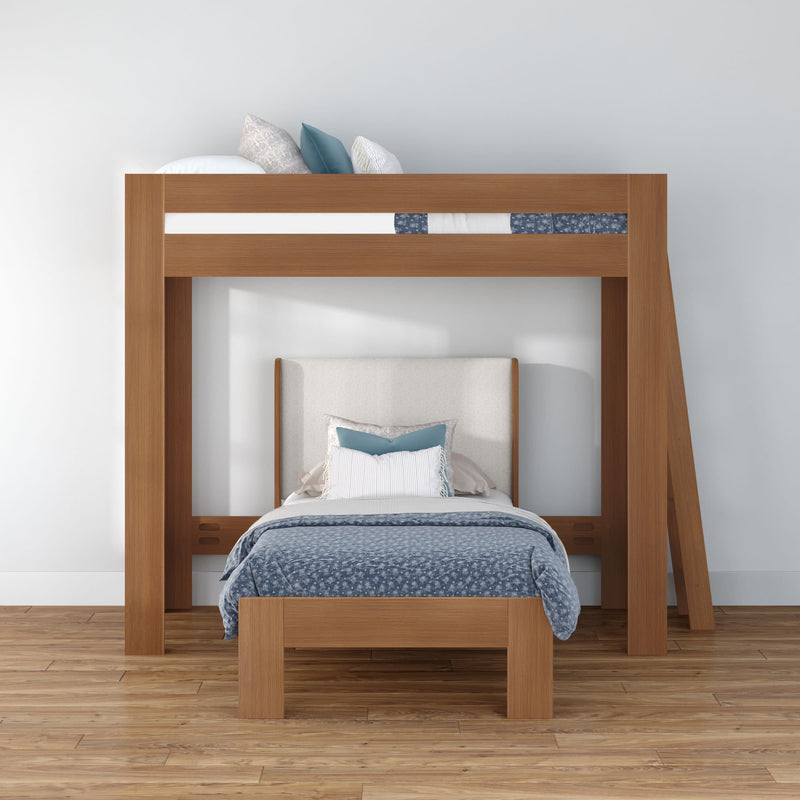 Modern solid wood loft bunk bed with lower twin bed, blue patterned duvet and decorative pillows in a minimalist bedroom with hardwood floors
