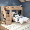 Light wood loft bunk bed with built-in stairs and open storage, full-size lower bed with coastal blue patterned bedding, striped rug, potted plant and navy blue accent wall in a modern space-saving kids' bedroom
