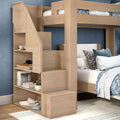 Wooden bunk bed with built-in storage staircase and open shelves in blue kids' bedroom, space-saving loft design with patterned bedding and rug