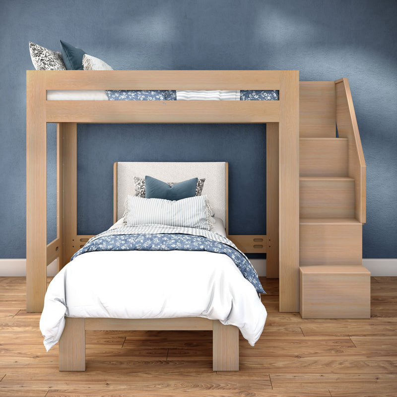 Wooden loft bed with staircase and lower twin bed, blue patterned bedding and pillows in a modern bedroom with hardwood floor and textured blue wall
