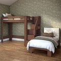 Modern wooden loft bed with built-in staircase and storage paired with a twin bed, green floral wallpaper and hardwood floor in a cozy bedroom