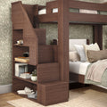 Dark wood loft bunk bed with built-in storage staircase and open shelving in cozy green floral bedroom.