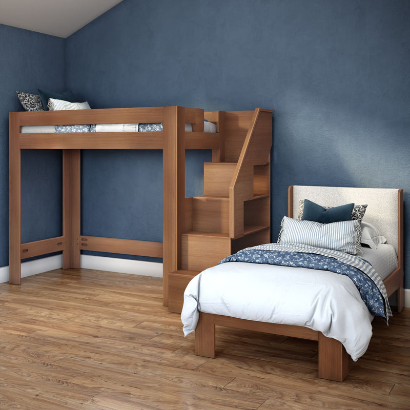 Kids bedroom with wooden loft bed and stairs, single bed with blue patterned bedding, navy textured wall and hardwood floor