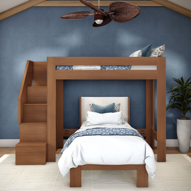 Twin-over-twin wooden loft bed with storage stairs, lower single bed, blue accent wall, coastal blue-and-white bedding and ceiling fan