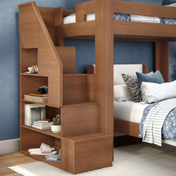 Modern wooden bunk bed with built-in storage stairs and open shelving, blue patterned bedding and striped pillows in a cozy kids' bedroom